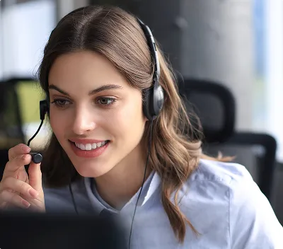 A smiling woman wearing a headset with a microphone