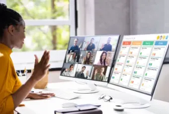 A Black woman in a yellow shirt on a video call